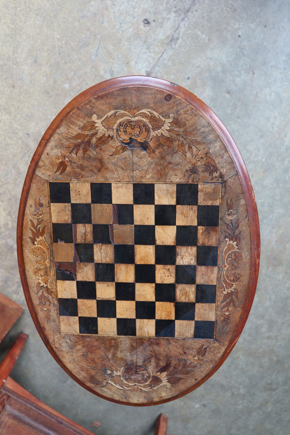 A Victorian inlaid walnut oval tripod games table, width 60cm depth 41cm height 71cm